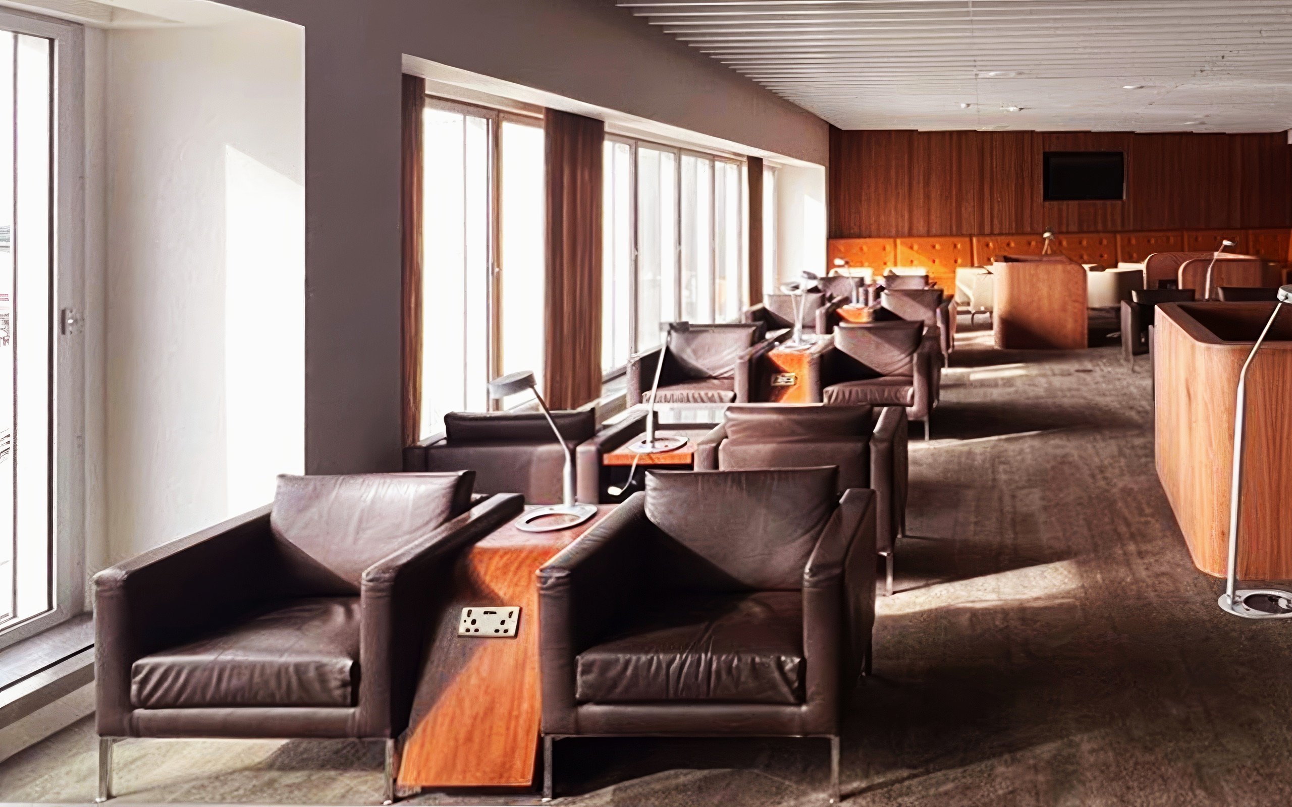 Blush Lounge seating area with leather chairs and tables, Terminal 4, London Heathrow Airport.