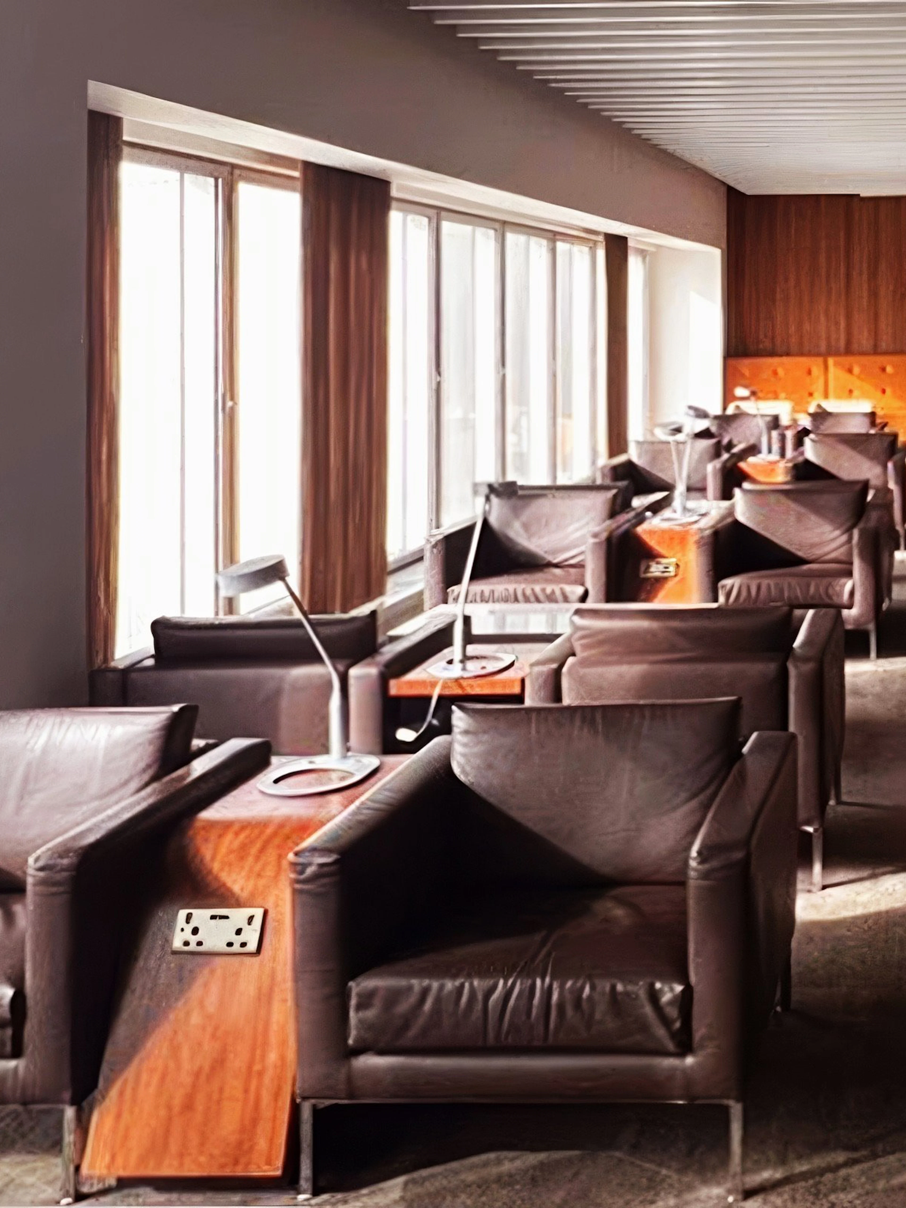 Blush Lounge seating area with leather chairs and tables, Terminal 4, London Heathrow Airport.