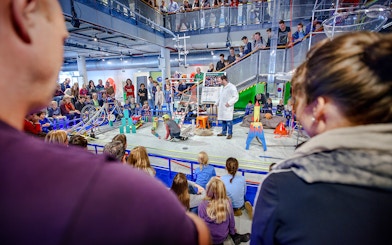 Parents observing children engaging with interactive exhibits at NEMO Science Museum.