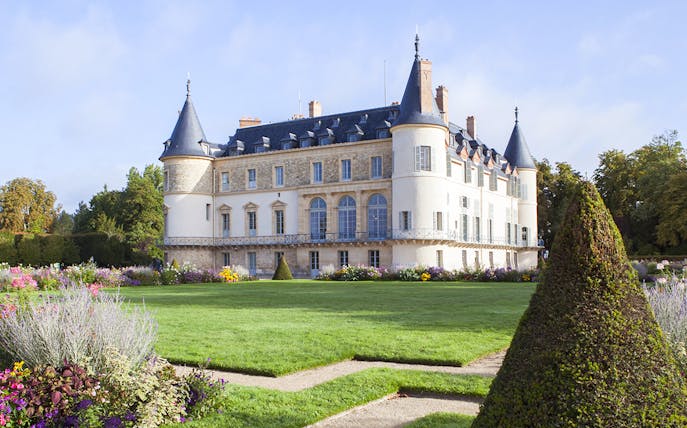 Castle of Rambouillet with gardens and manicured hedges in France.