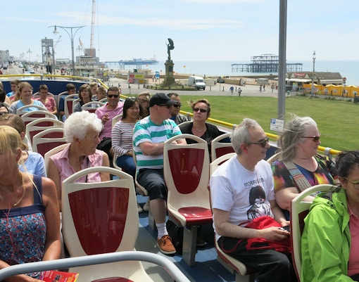 A group of people enjoying the upper deck of the HOHO Bus in New Orleans.