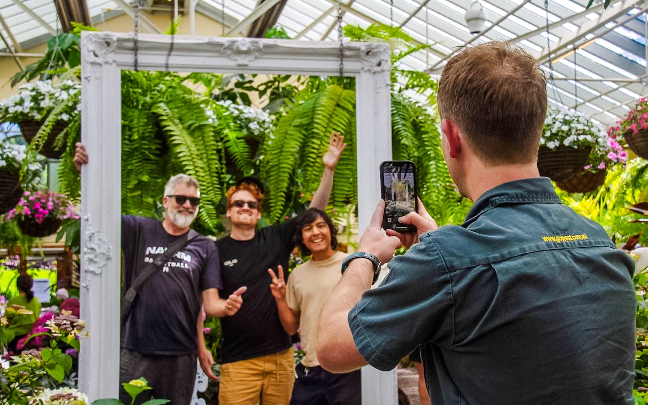 Visitors posing for a photo in the Conservatory at Fitzroy Gardens, Melbourne.