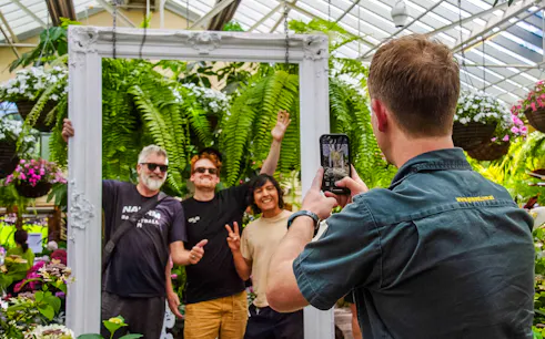 Visitors posing for a photo in the Conservatory at Fitzroy Gardens, Melbourne.