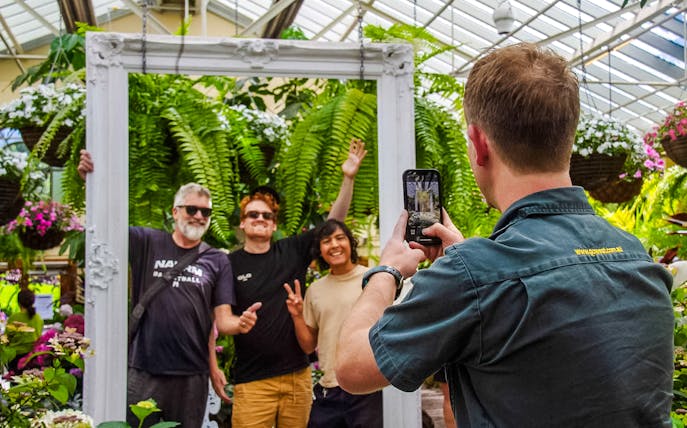Visitors posing for a photo in the Conservatory at Fitzroy Gardens, Melbourne.