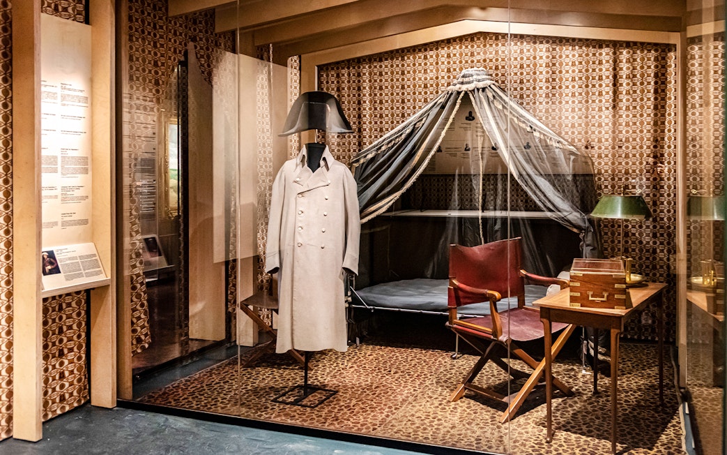 Napoleon's uniform display at Army Museum, Paris, with historical artifacts.