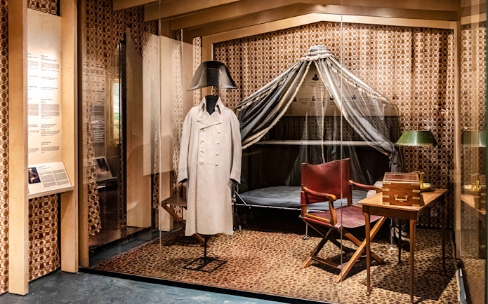Napoleon's uniform display at Army Museum, Paris, with historical artifacts.