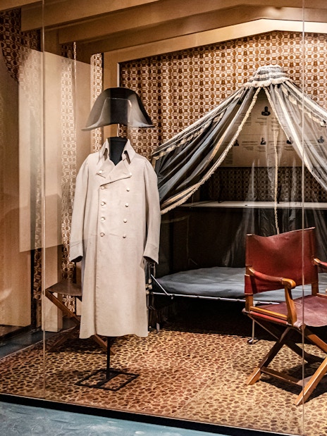 Napoleon's uniform display at Army Museum, Paris, with historical artifacts.