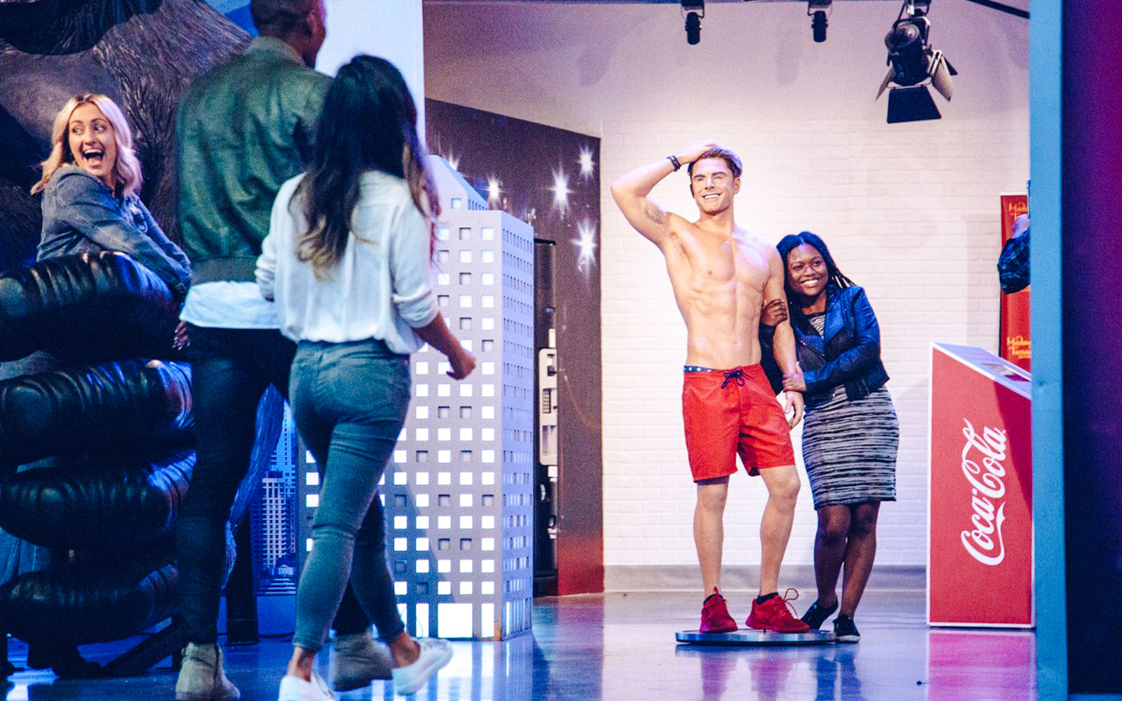 Visitors posing with a wax figure at Madame Tussauds Hollywood.