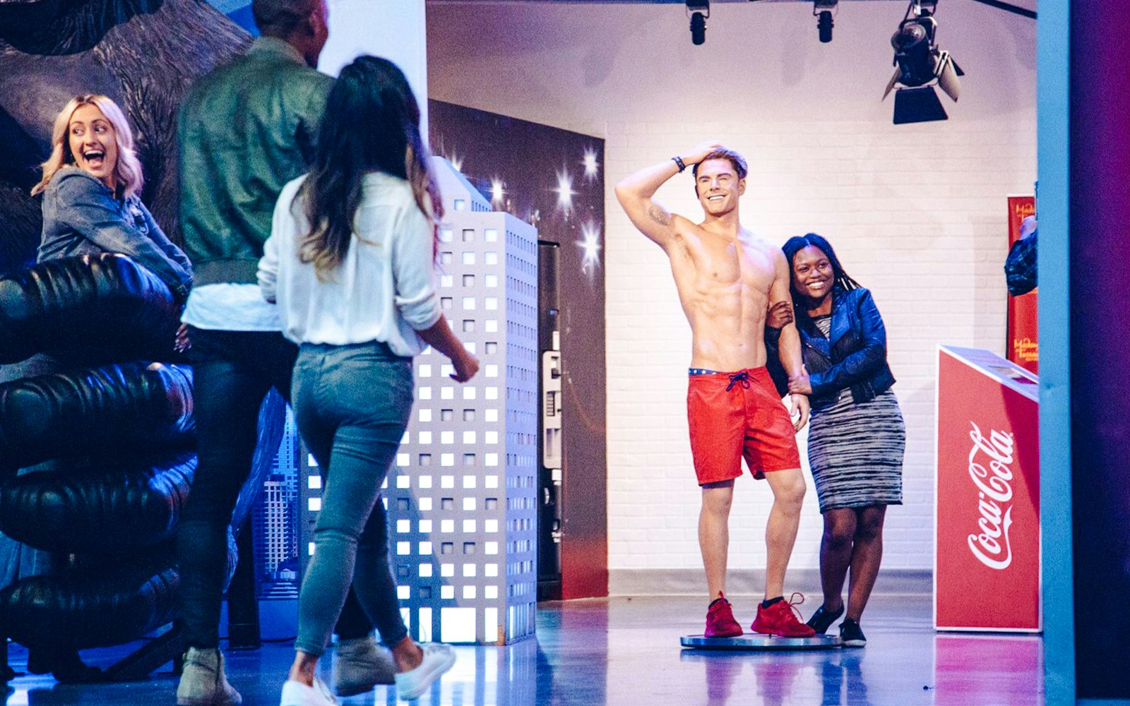 Visitors posing with a wax figure at Madame Tussauds Hollywood.