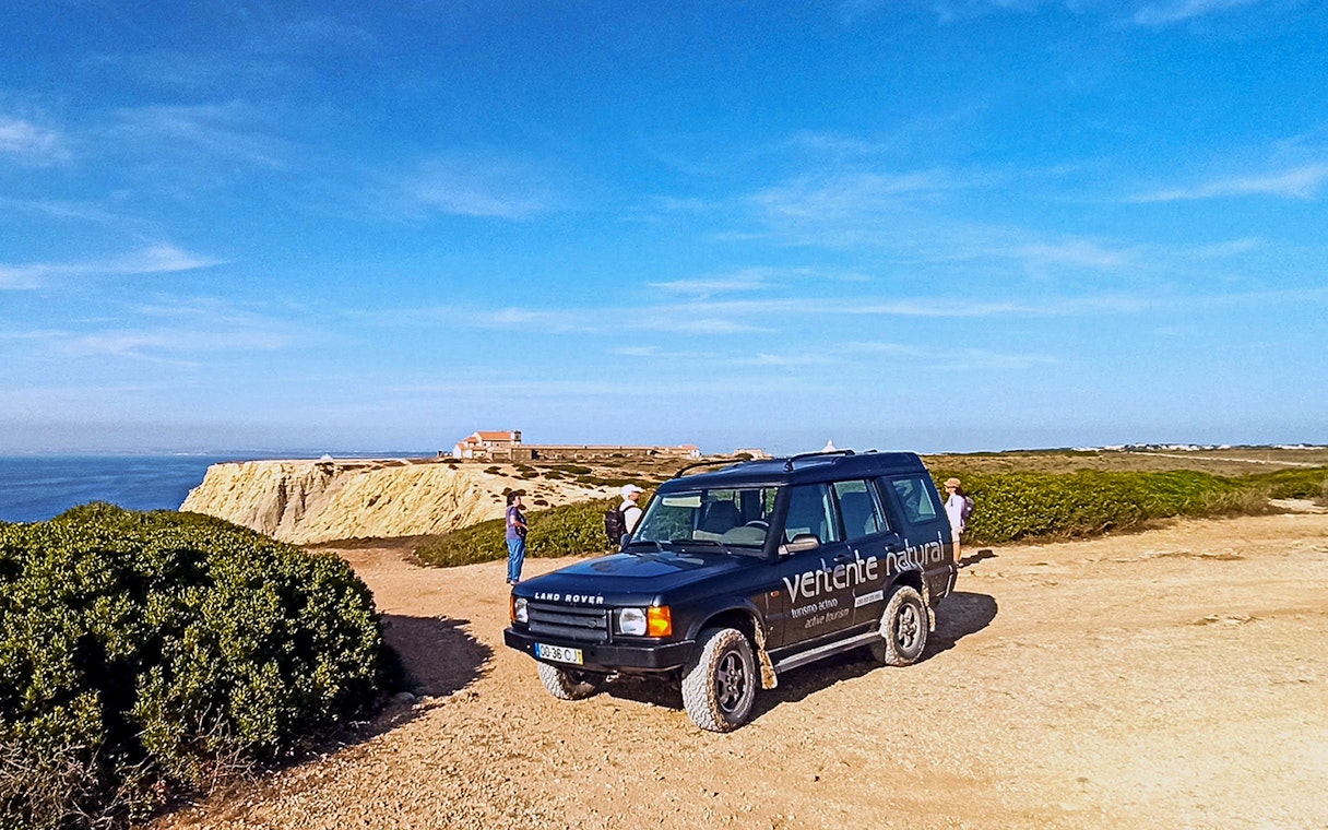 4x4 Jeep on Cape Espichel cliffside, part of guided tour in Sesimbra, Portugal.