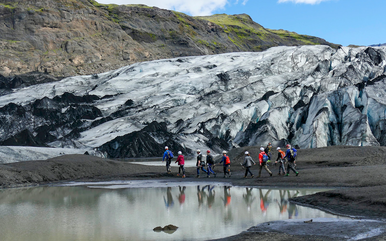Group hiking near Sólheimajökull Glacier on South Coast Half Day Tour.