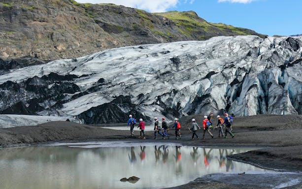 Group hiking near Sólheimajökull Glacier on South Coast Half Day Tour.