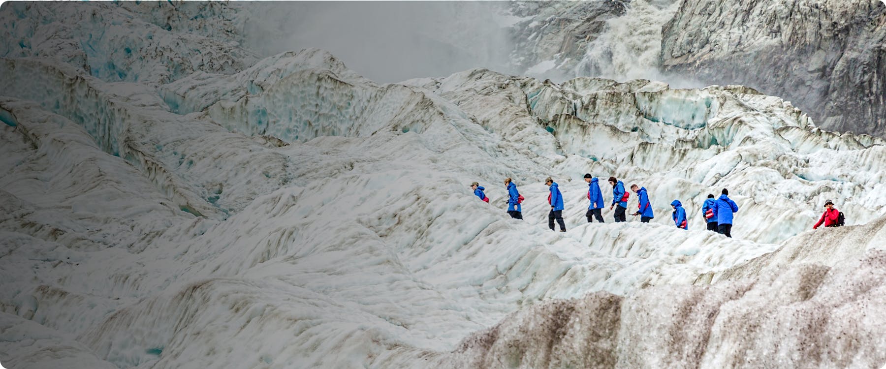 Tourists hiking on Franz Josef Glacier in New Zealand.