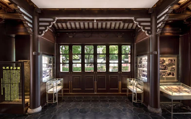 Interior of Huxinting Teahouse with display cases and traditional decor, Yu Garden, Shanghai.