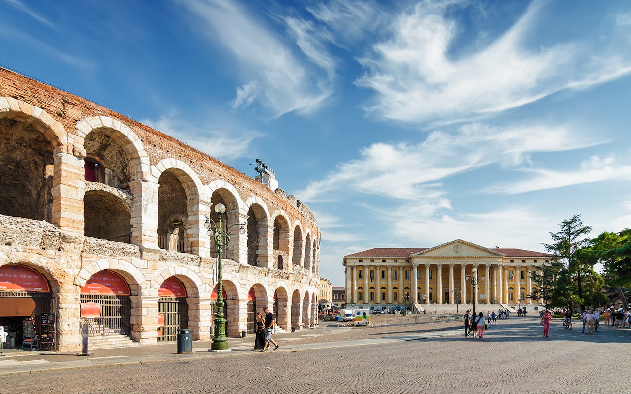 Verona Arena and Palazzo Barbieri under blue sky during guided tour from Lake Garda.
