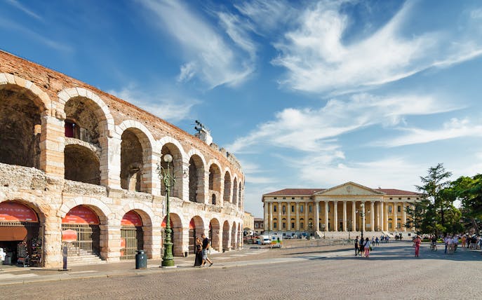 Verona Arena and Palazzo Barbieri under blue sky during guided tour from Lake Garda.