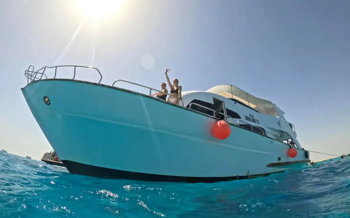 Boat with tourists in Hurghada for sunset dive, dolphin watching, and snorkeling.