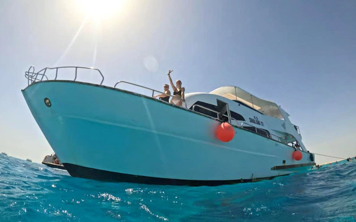 Boat with tourists in Hurghada for sunset dive, dolphin watching, and snorkeling.