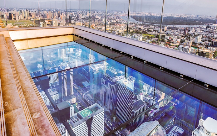 Mahanakhon SkyWalk glass floor with Bangkok cityscape view, Thailand.