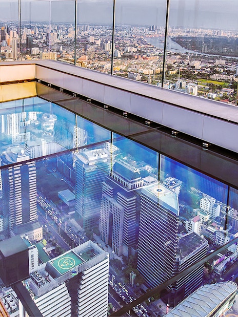 Mahanakhon SkyWalk glass floor with Bangkok cityscape view, Thailand.