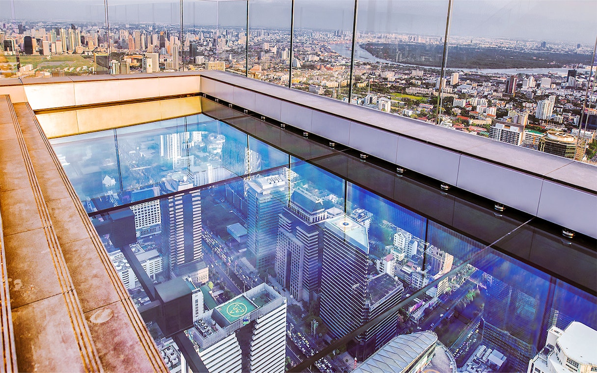 Mahanakhon SkyWalk glass floor with Bangkok cityscape view, Thailand.