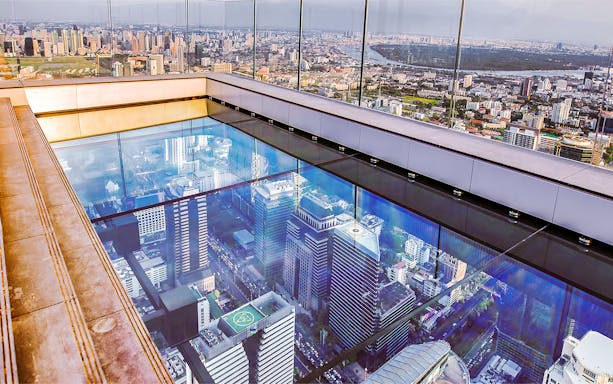 Mahanakhon SkyWalk glass floor with Bangkok cityscape view, Thailand.
