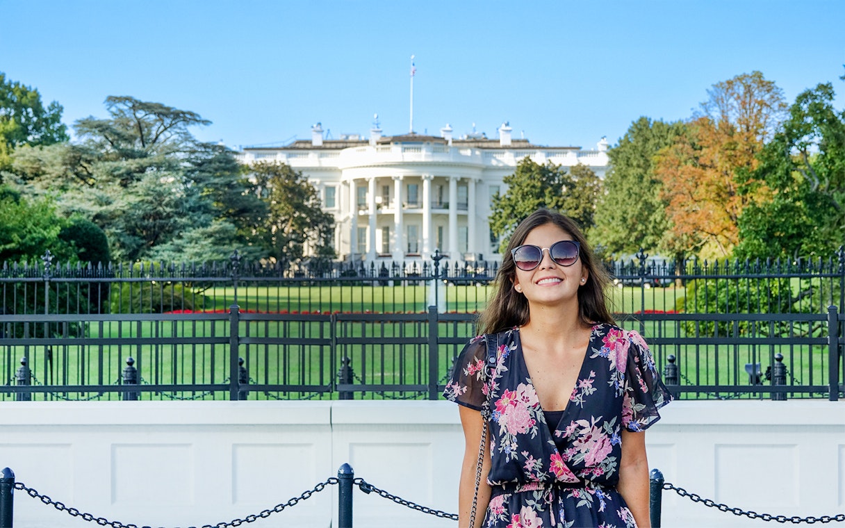 Tourist smiling in front of The White House, Washington DC, USA.