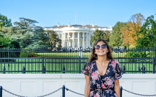 Tourist smiling in front of The White House, Washington DC, USA.