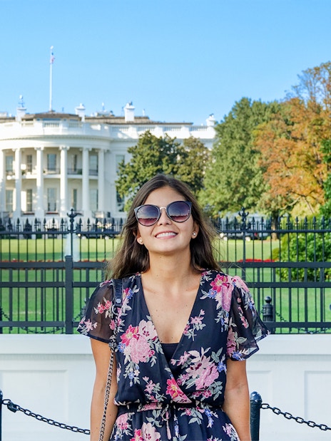 Tourist smiling in front of The White House, Washington DC, USA.