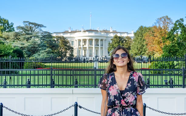 Tourist smiling in front of The White House, Washington DC, USA.