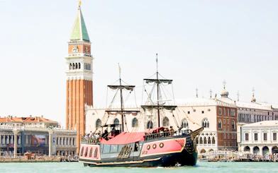 Galleon sailing past St. Mark's Campanile in Venice during dinner cruise.
