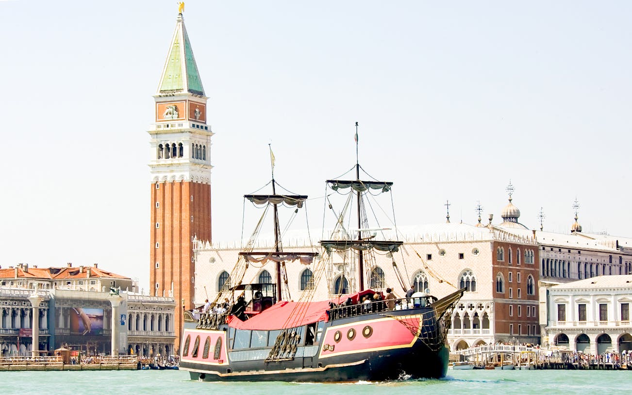 Galleon sailing past St. Mark's Campanile in Venice during dinner cruise.