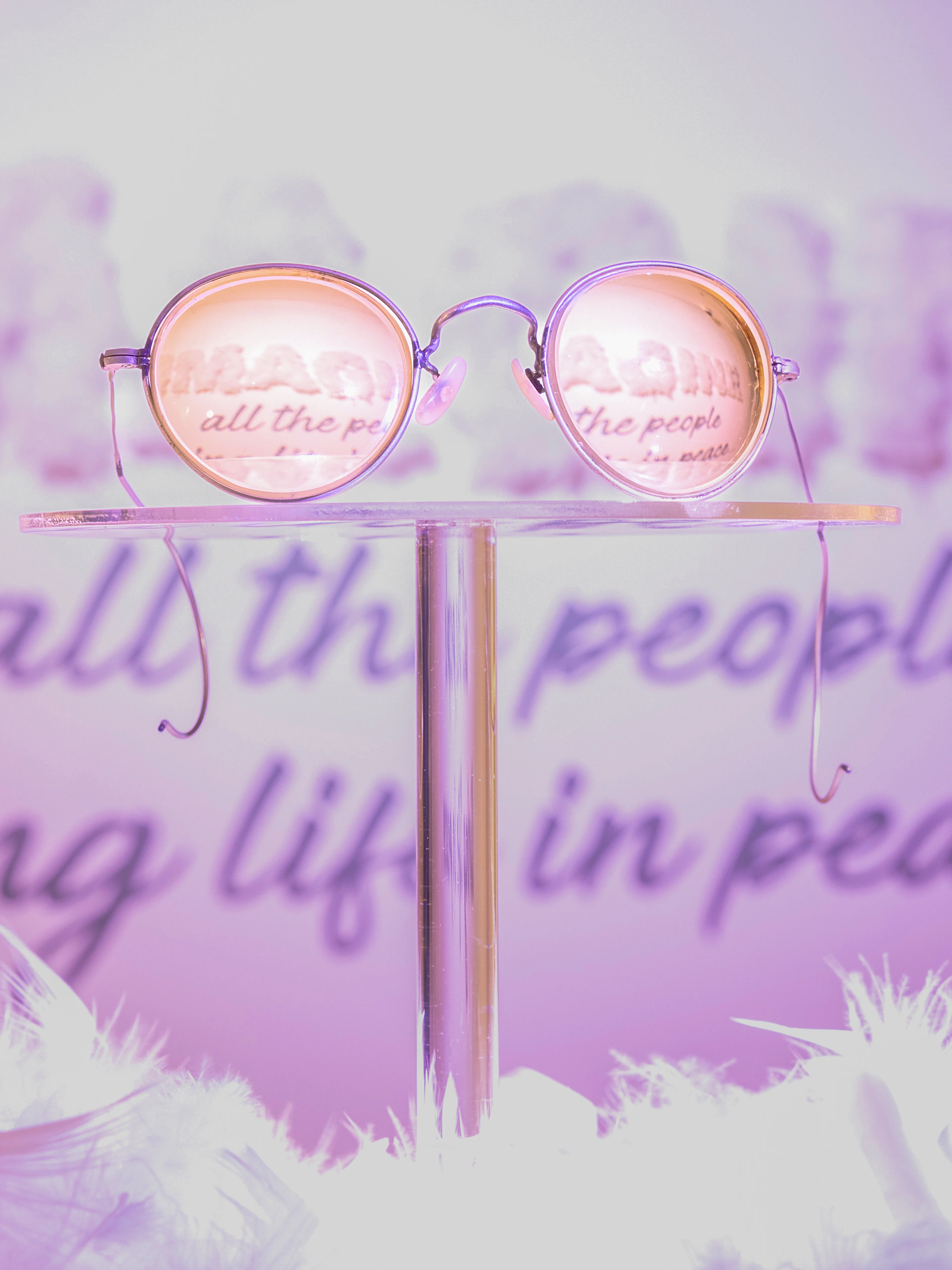 Round glasses reflecting "Imagine" lyrics at The Beatles Story exhibit.