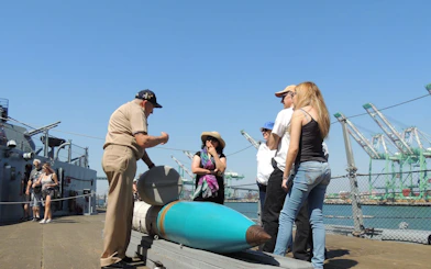 Group on ship deck during guided tour with crew stories and scavenger hunt access.