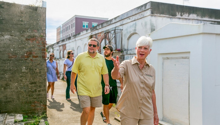 Tour guide leading guests through St. Louis Cemetery in New Orleans.