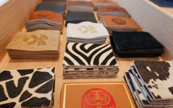 Swatches of back pocket labels with various patterns at Harajuku Tokyo Denim Jeans Making Experience.