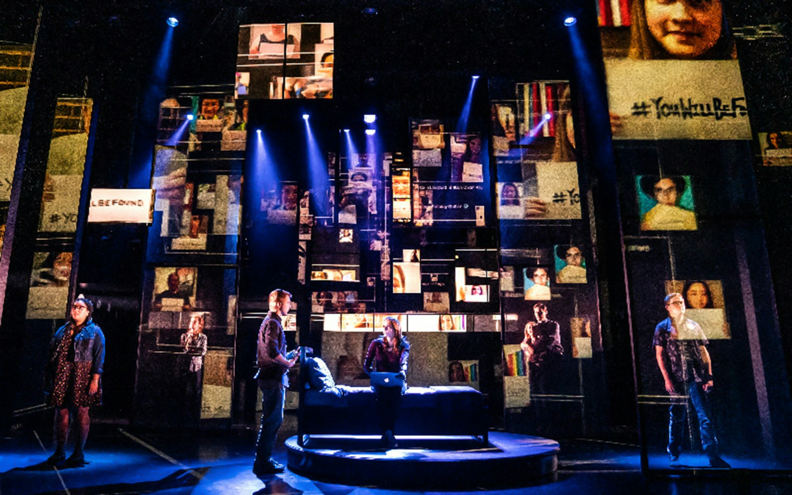 Stage scene from Dear Evan Hansen musical with actors and digital screens.