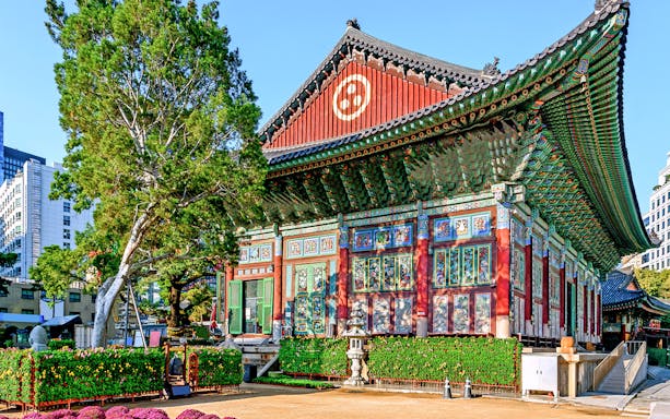 Traditional Korean temple in Seoul with colorful architecture and surrounding greenery.