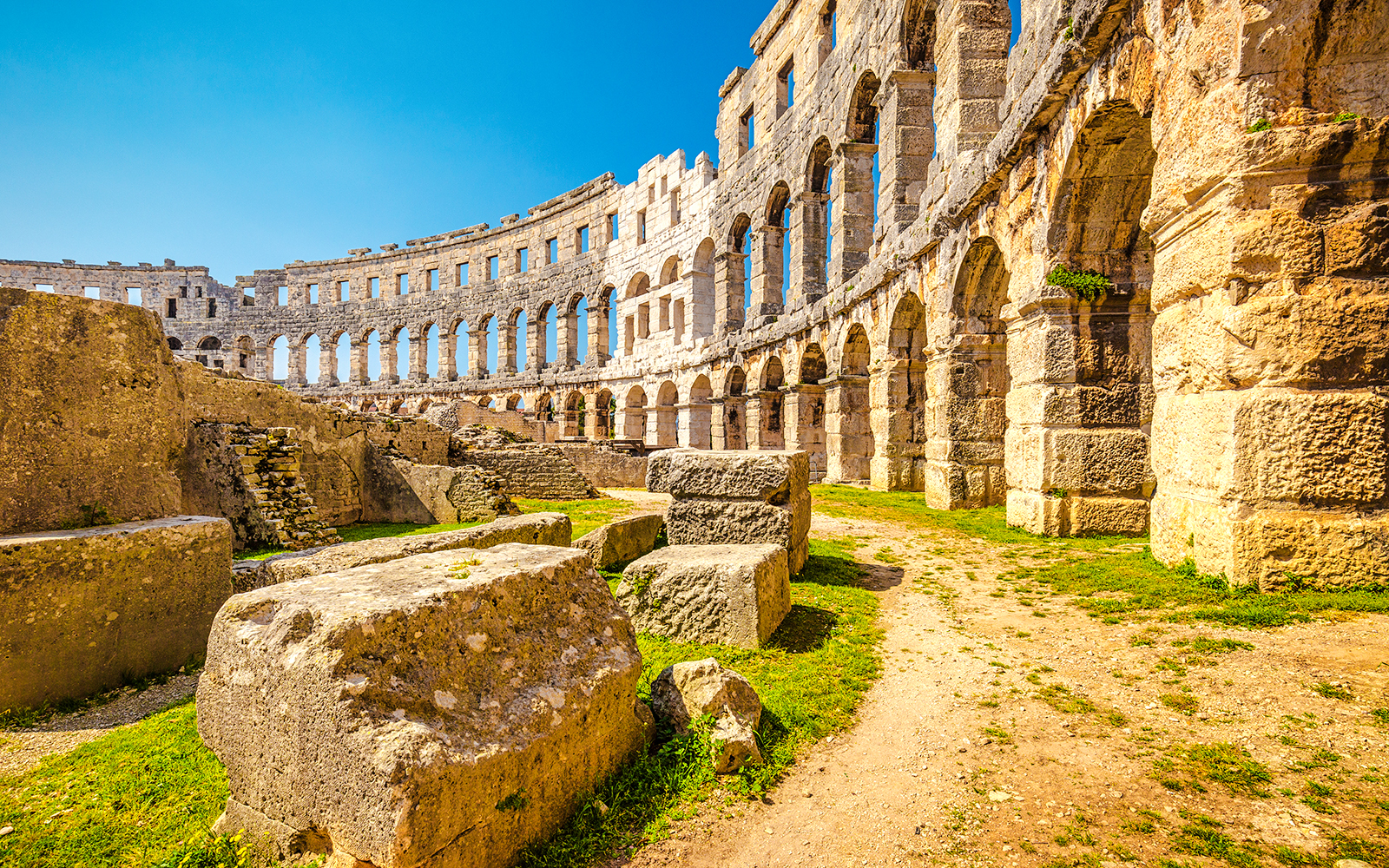 Roman Arena in Pula, Croatia with ancient stone arches and ruins.