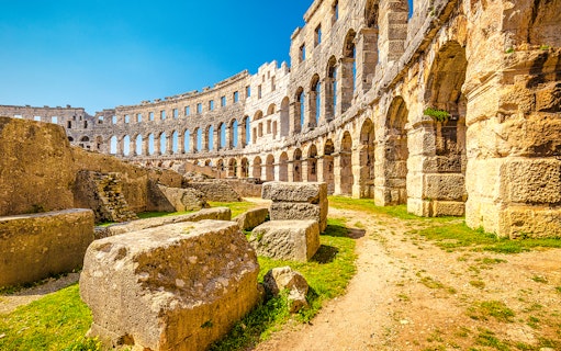 Roman Arena in Pula, Croatia with ancient stone arches and ruins.