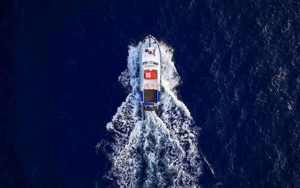 Boat cruising near Blue Lagoon, Malta, viewed from above.