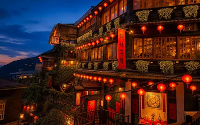 Red lantern-lit buildings in Jiufen, New Taipei City, Taiwan, at dusk.