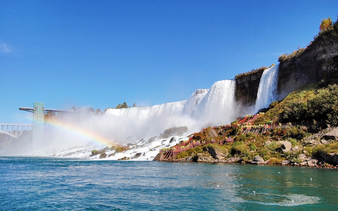 Niagara Falls with American Falls and Bridal Veil Falls, rainbow visible over water.