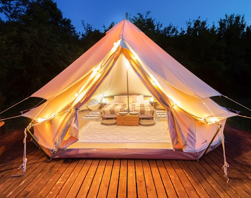 Glamping tent with cozy interior on a wooden deck at Southern Islands.
