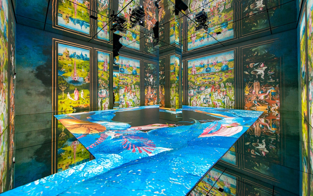 Beyond Reality gallery projections at Frameless London, featuring vibrant art displays on walls and floor.