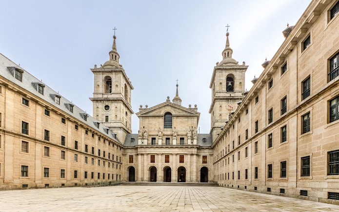 El Escorial's Court of Kings, featuring statues and twin towers in Madrid, Spain.