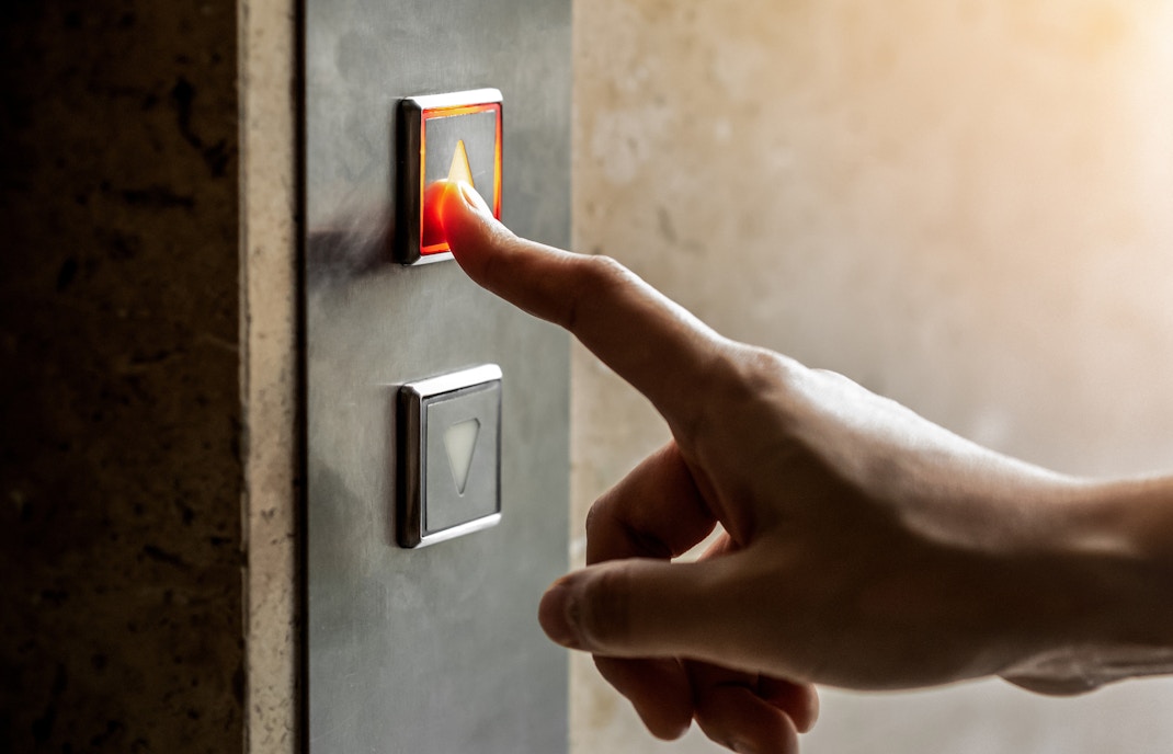 Person pressing the elevator button