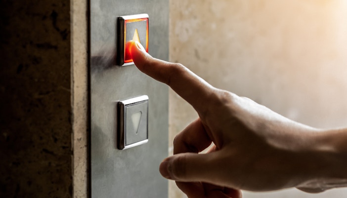 Person pressing the elevator button