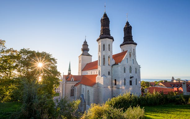Visby Cathedral with twin towers and red roofs in sunlight, Gotland, Sweden.