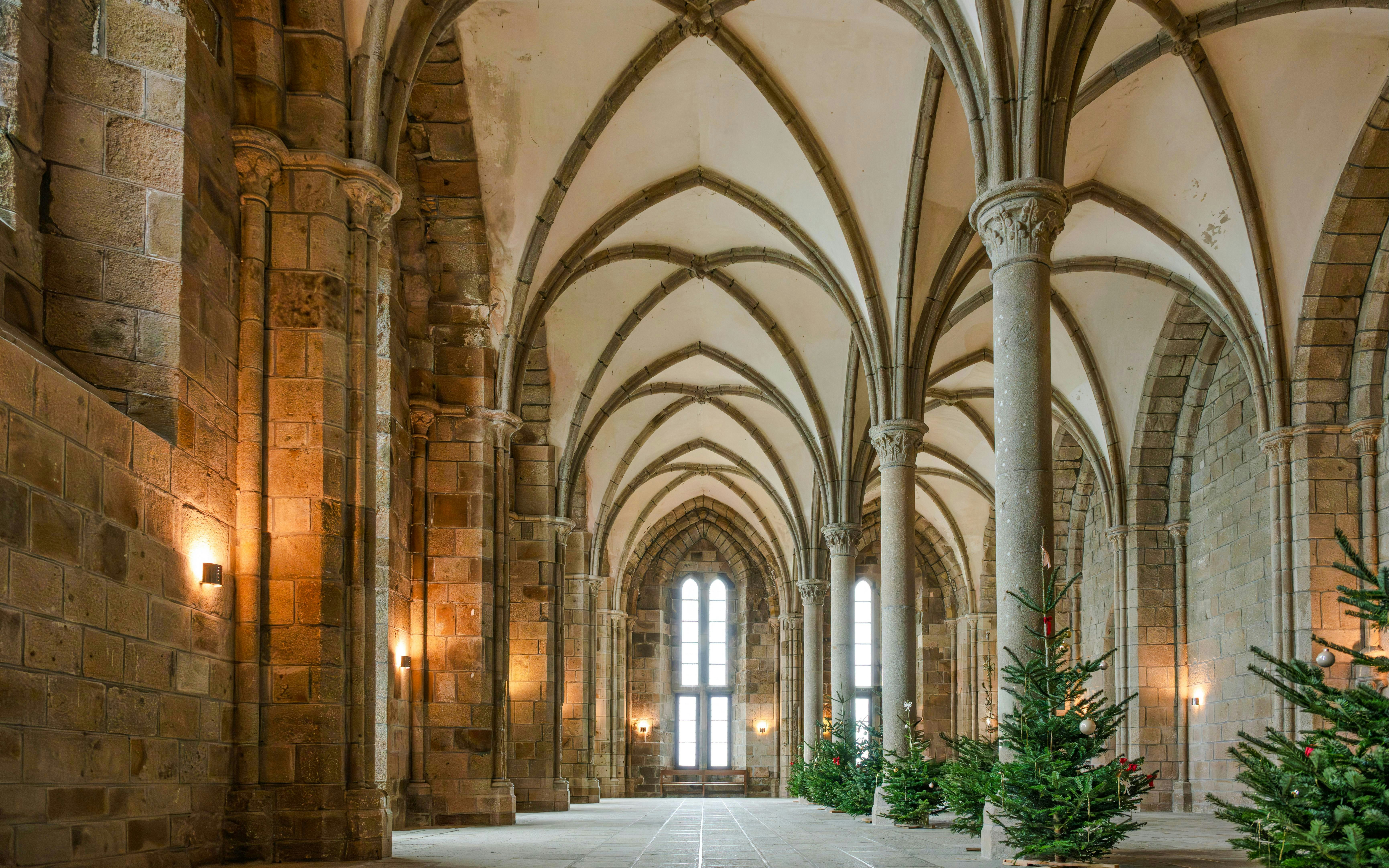 Mont-Saint-Michel Abbey Church interior with vaulted ceilings and stone columns.